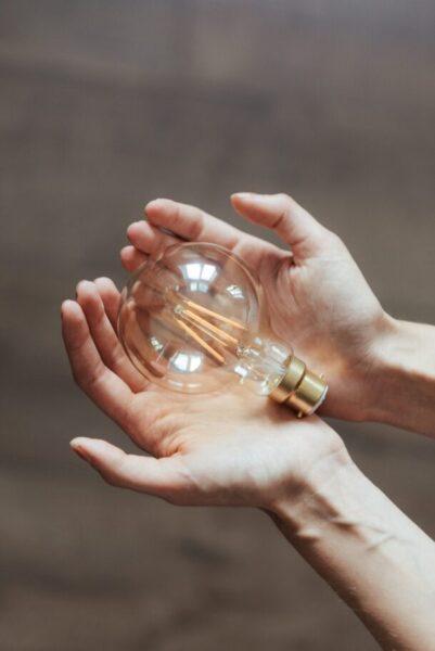 Holding a lightbulb with both hands